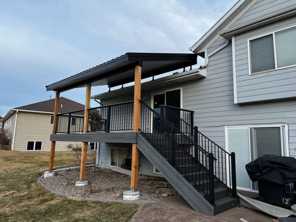 New upper level modern deck with stairs and support beams